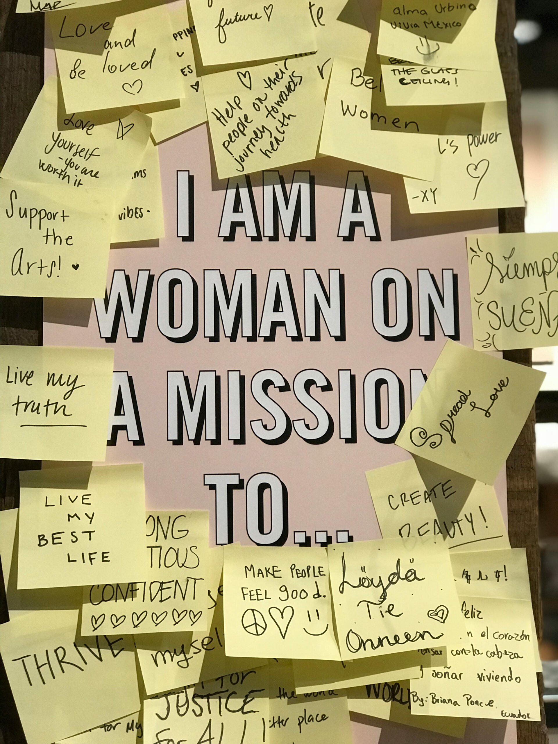 “Bulletin board covered with handwritten notes around the phrase ‘I am a woman on a mission to…,’ representing empowerment, purpose, and women rebuilding their lives.”
